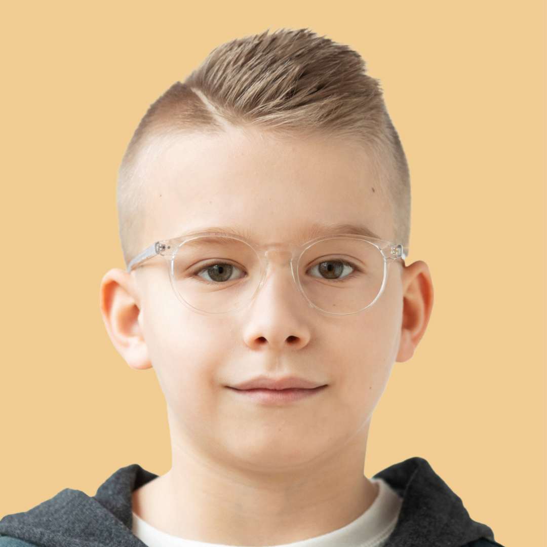 Boy wearing clear round glasses and a gray shirt 