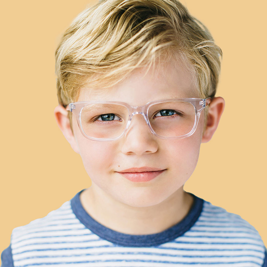 Boy wearing clear rectangle glasses and a blue shirt 