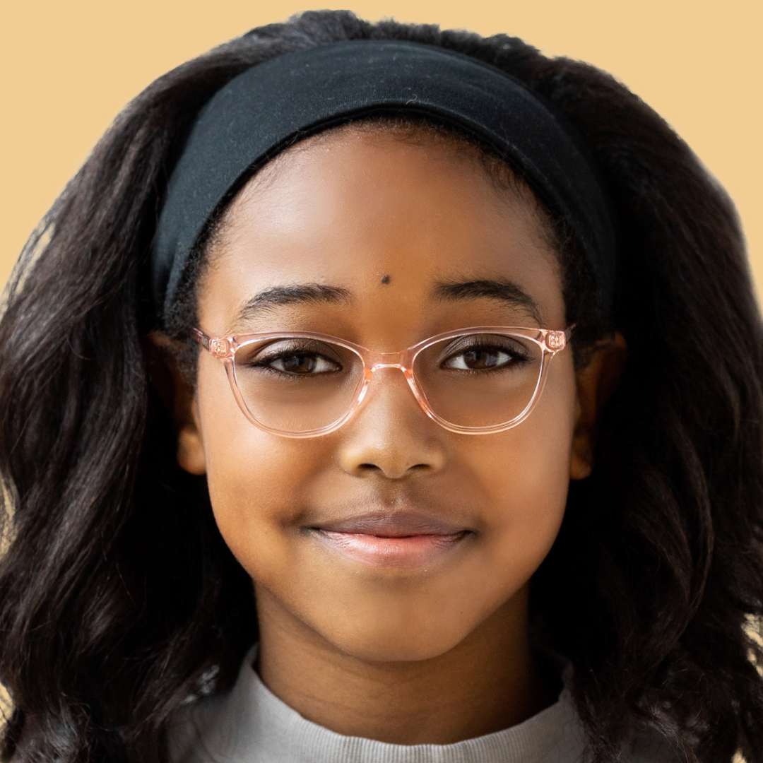 Girl wearing pink cat eye glasses and a gray shirt 