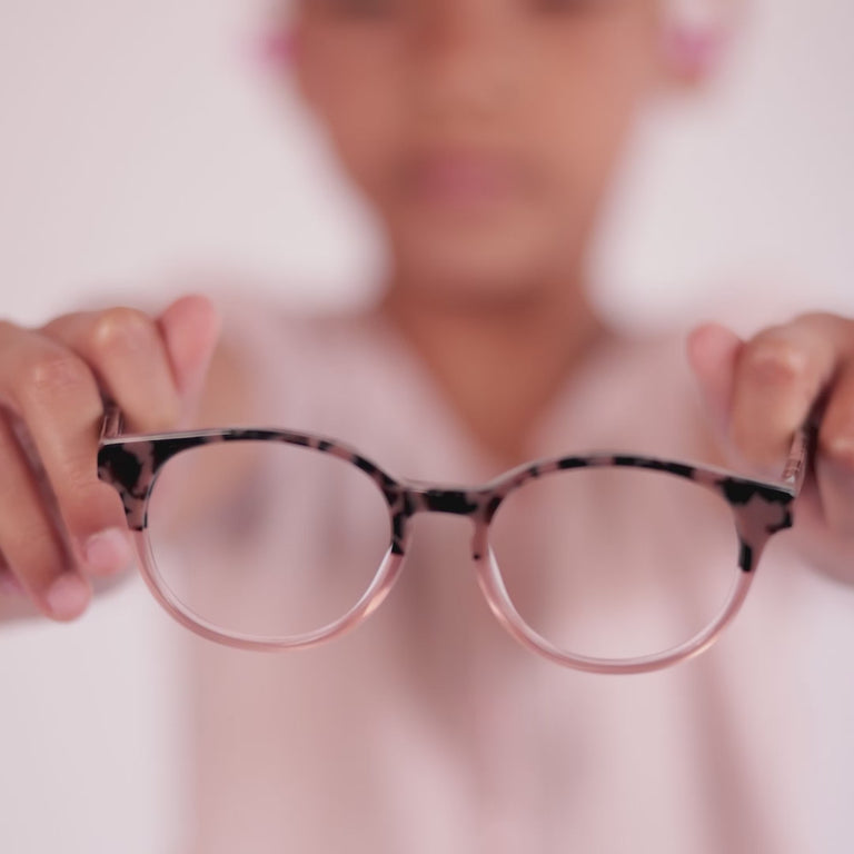 Girl wearing Medium (46-16-130) / Blush Tortoise round glasses [variants=22362866974805, 22362866483285] [color=Blush Tortoise] [size=Medium (46-16-130), Small (43-15-125)][child face]