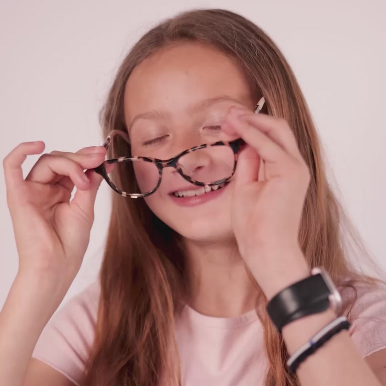 Girl wearing Medium (47-16-130) / Crystal Tortoise cat eye glasses 
 [variants=39279199092821, 39279198044245] [color=Crystal Tortoise] [size=Medium (47-16-130), Small (44-16-125)] [child face]