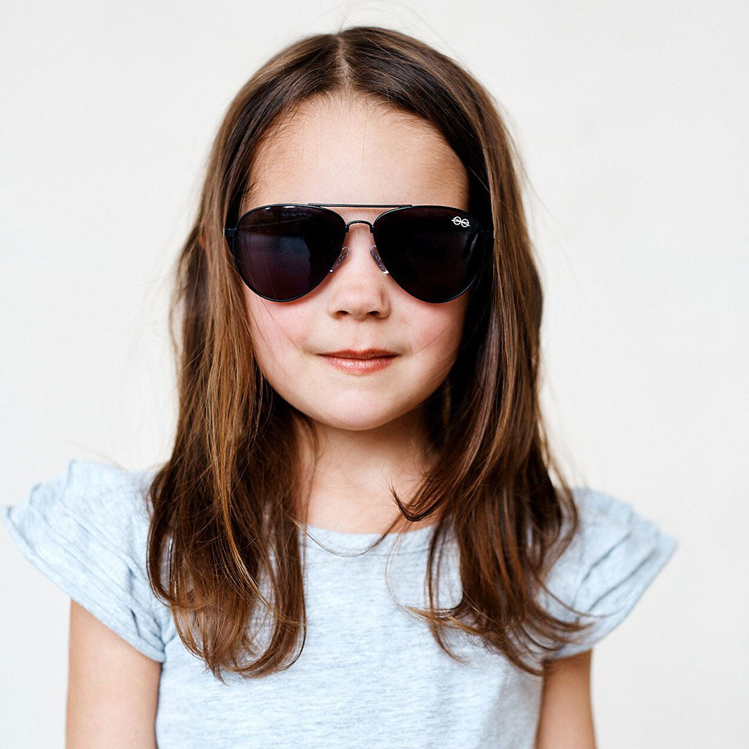 Girl wearing Large (50-13-125) / Matte Black aviator sunglasses 